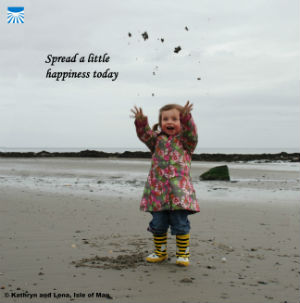 Little girl throwing sand in the air with text: Spread a little happiness today.